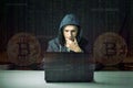 Hacker with a face is trying to steal cryptocurrency using a computer. Fraud and scam at Cryptojacking Royalty Free Stock Photo