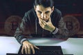 Hacker with a face is trying to steal cryptocurrency using a computer. Fraud and scam at Cryptojacking Royalty Free Stock Photo