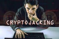 Hacker with a face is trying to steal cryptocurrency using a computer. Fraud and scam at Cryptojacking Royalty Free Stock Photo