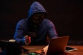 Hacker finding and exploiting the weakness in computer systems to gain access.