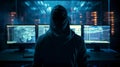 Hacker in front of a computer with many data on the screens the hacker is wearing a dark hoodie Royalty Free Stock Photo