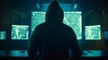 Hacker in front of a computer with many data on the screens the hacker is wearing a dark hoodie Royalty Free Stock Photo
