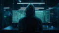 Hacker in front of a computer with many data on the screens the hacker is wearing a dark hoodie Royalty Free Stock Photo