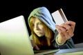 Hacker girl holding credit card violating privacy holding credit card in cybercrime and cyber crime Royalty Free Stock Photo