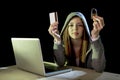 Hacker girl holding credit card violating privacy holding credit card in cybercrime and cyber crime Royalty Free Stock Photo