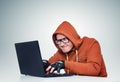 Hacker in glasses with a laptop