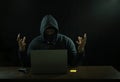 Hacker hacking fail at night, stress man in black hoodie having a gun,credit card and laptop.concept hacker, cyber crime