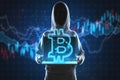Hacker hands holding laptop with creative glowing polygonal bitcoin city hologram on blurry blue background with forex chart. Royalty Free Stock Photo