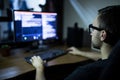 hacker in headset and eyeglasses with keyboard hacking computer system