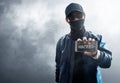 Hacker use mobile phone on smoke background Royalty Free Stock Photo