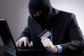 Hacker holding a credit card