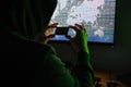 Hacker holding a credit card front of a computer for organizing massive data breach attack around the world Royalty Free Stock Photo