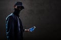 Hacker holding mobile phone Royalty Free Stock Photo