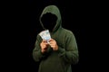 Hacker holding Rupiah paper money isolated on black background