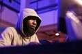Hacker in hood breaking into database