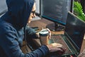 Hacker in a hood are programming virus code on a laptop. The concept of Internet fraud and personal data hacking Royalty Free Stock Photo