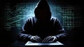 Hacker in hoodie accessing laptop in dark room with code on screen