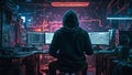 A hacker in a hoodie sitting at a computer desk.