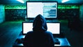 Hacker in hoodie working in cellar. Computer monitors. Dark net. Back view. Data thief, internet fraud
