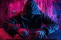 Hacker in hoodie working on laptop with digital code overlay Royalty Free Stock Photo