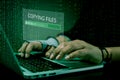 Hacker initiating file-transfer with binary code background. Royalty Free Stock Photo