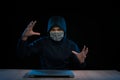 Hacker with laptop initiating cyber attack, isolated on black backgroung