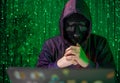 Hacker with laptop among matrix effect