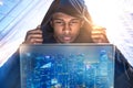 Hacker with laptop in modern city Royalty Free Stock Photo