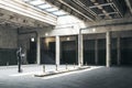 Hacker with laptop standing in modern parking garage