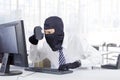 Hacker looking for information in office Royalty Free Stock Photo