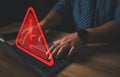 Hacker or programmer using laptop with triangle caution warning sign, coding, cryptography, hacker, crime, virus, Royalty Free Stock Photo
