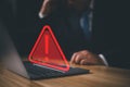 Hacker or programmer using laptop with triangle caution warning sign, coding, cryptography, hacker, crime, virus, Royalty Free Stock Photo