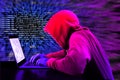 Hacker in a purple hoody in front of a blue code background with binary streams and information security terms cybersecurity