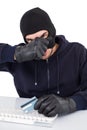 Hacker removing his balaclava to show his face