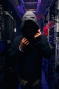 Hacker in server room attempting to cover his face