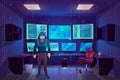Hacker in server room, multiple computer monitors Royalty Free Stock Photo