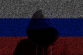 Hacker shininhg through russian computer code flag