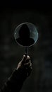 Hacker silhouette in a magnifying glass illustrating digital investigation and surveillance themes.