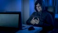 Portrait of hacker smiling and relaxing in chair after writing program code at night Royalty Free Stock Photo
