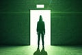 Hacker stands in front of an open elevator door
