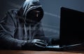 Hacker stealing data from a laptop Royalty Free Stock Photo