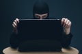 Hacker stealing data off a laptop computer