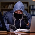 Hacker stealing personal data from home computer Royalty Free Stock Photo