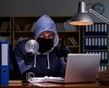 Hacker stealing personal data from home computer Royalty Free Stock Photo