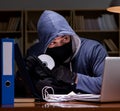 Hacker stealing personal data from home computer Royalty Free Stock Photo