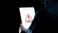 Hacker tablet cyber security. Digital mobile phone in hacker man hand isolated on black banner. Internet web hack