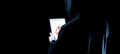 Hacker tablet cyber security. Digital mobile phone in hacker man hand isolated on black banner. Internet web hack