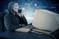 Hacker talking on mobile phone with vendetta mask Royalty Free Stock Photo