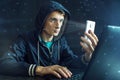 Hacker is trying to hack into the phone using the personal identification method of face recognition Royalty Free Stock Photo