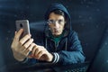 Hacker is trying to hack into the phone using the personal identification method of face recognition Royalty Free Stock Photo